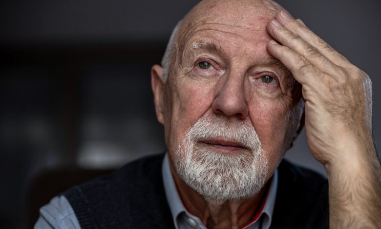 Portrait of a senior man suffering from a headache