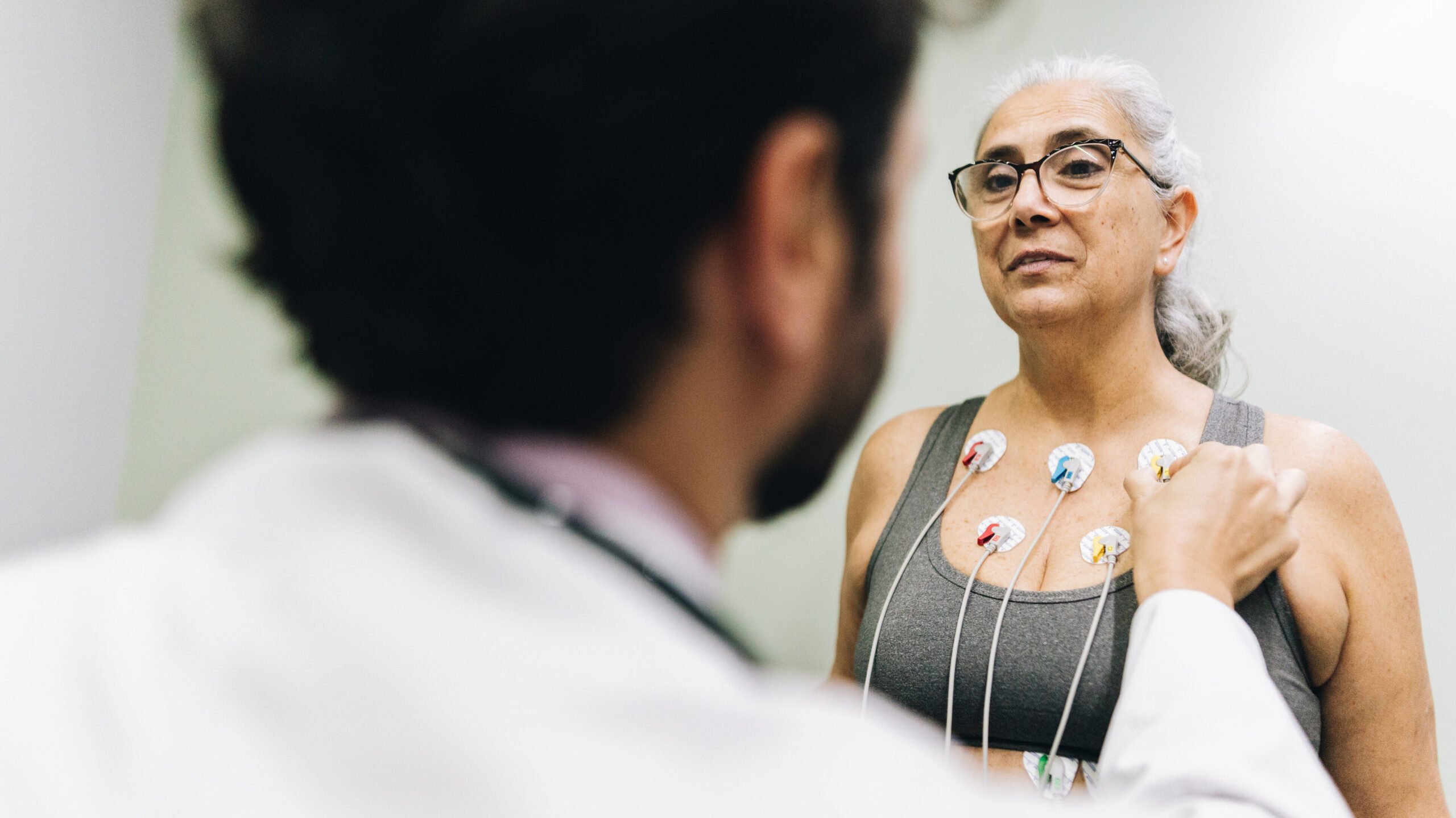 Patient talking with her doctor during a cardiopulmonary stress test on a hospital