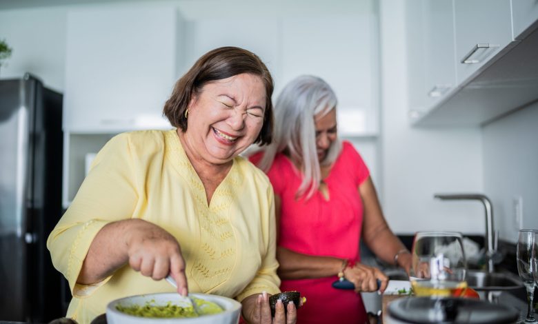 Mature women preparing guacamole at a domestic kitchen