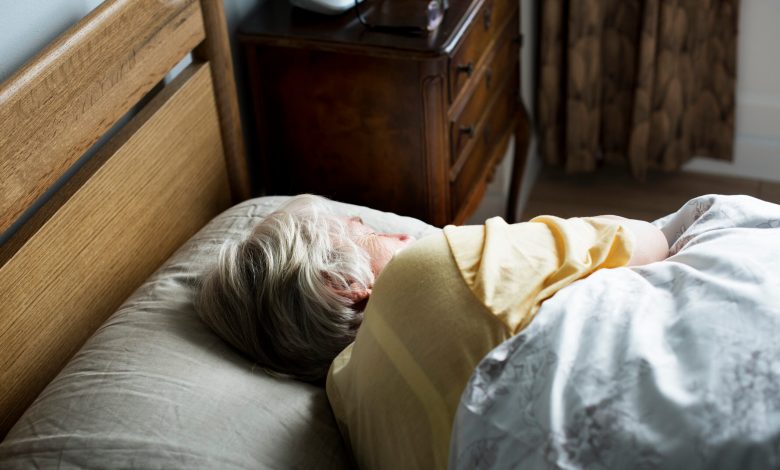 Elderly caucasian woman sleeping on the bed