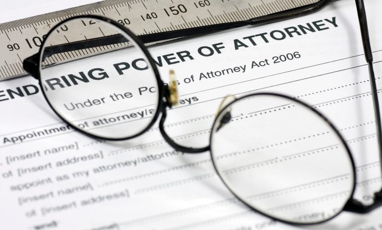Close up of Power of Attorney contract with reading glasses