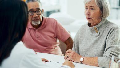 Doctor, consultation and discussion with elderly couple for insurance or healthcare policy at hospital. Medical employee, caregiver or nurse with senior patients for health prescription at clinic