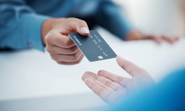 Corporate hands exchange credit card to accountant for payment for company tax bills, money loan and accounting fees. Businessman with banking card to invest in financial savings budget investment