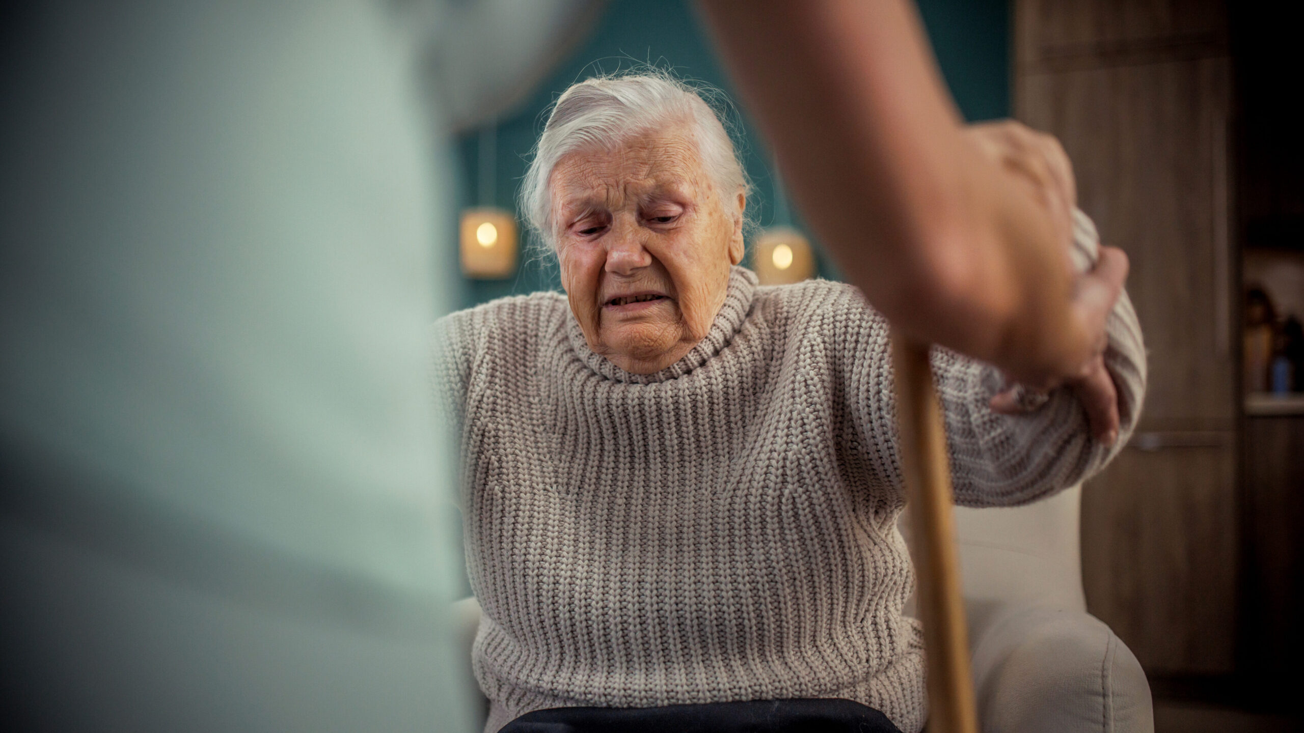 Caregiver supporting disabled woman in standing