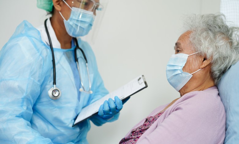 Doctor check Asian elder senior woman patient wearing a mask for protect covid coronavirus.